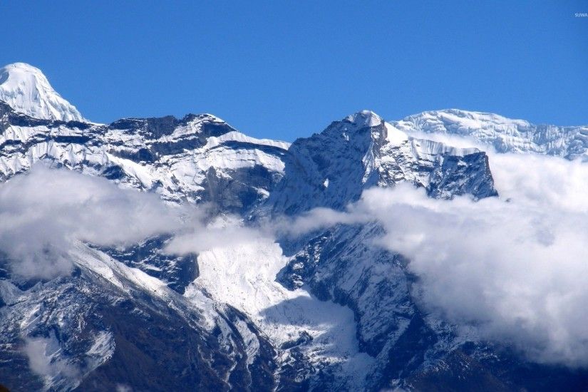 Snowy Himalayas higher than clouds wallpaper