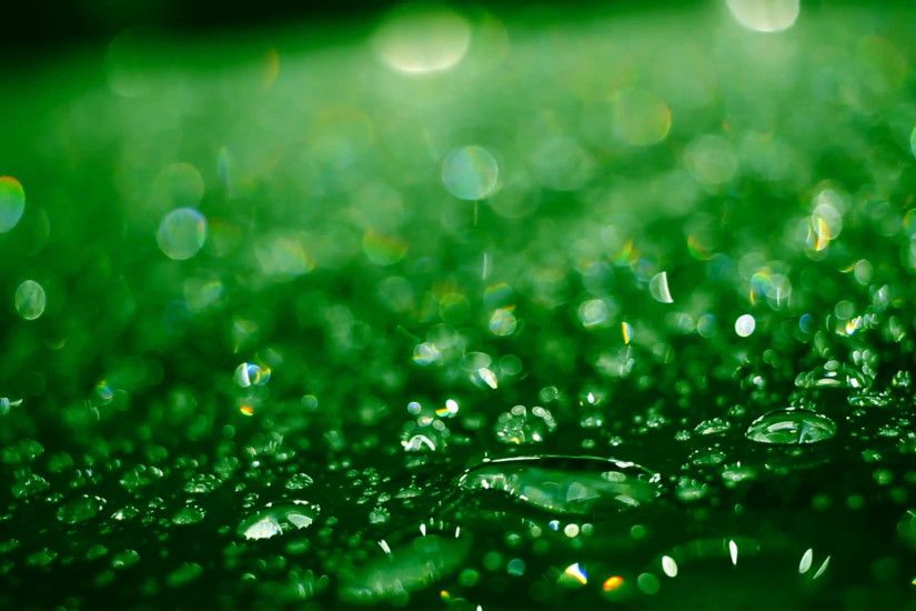Droplets on glass after rain. Closeup of shiny water drops on glass after  rain. Green colored water droplets on glass. Water droplets. Abstract  background ...