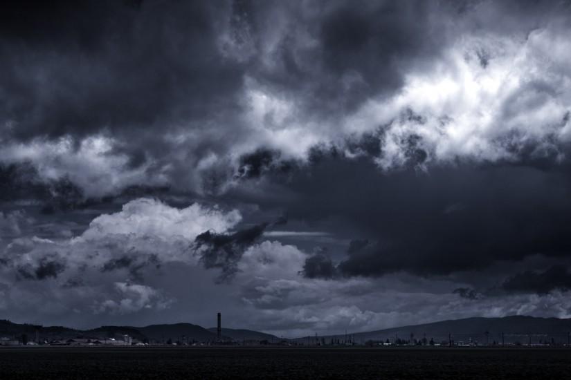 Storm Clouds Forming Over A Rural Village Wide Desktop Background wallpaper  free