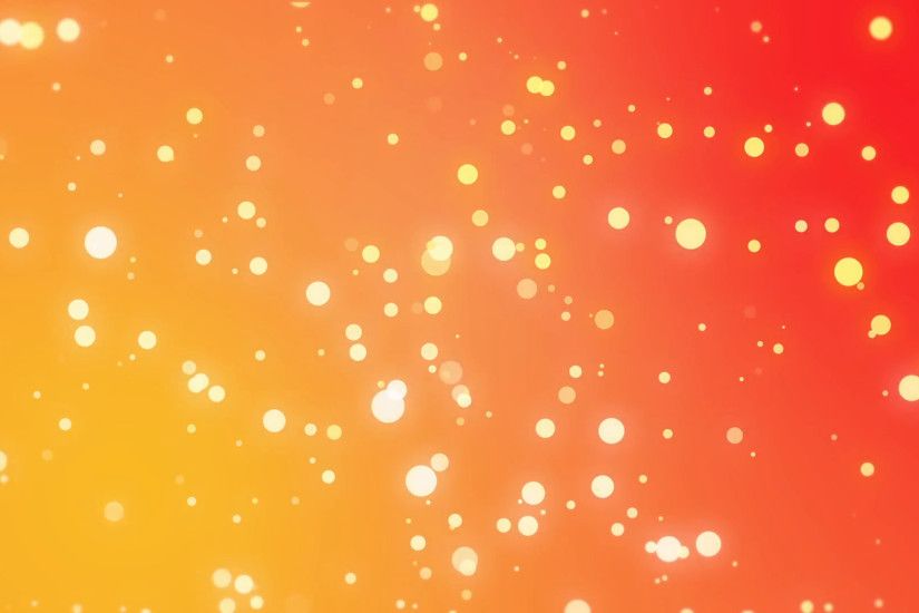 Sparkly light particles moving across a yellow orange red gradient  background