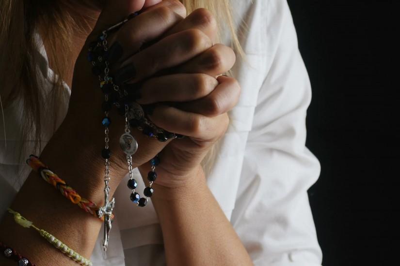 woman is praying on dark background with rosary beads: cross, religion, God  Stock Video Footage - VideoBlocks