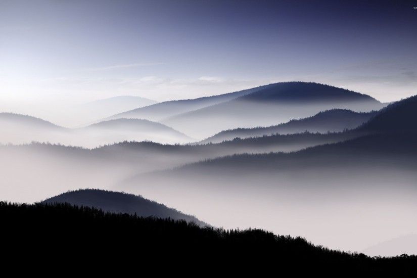 Fog covered mountain range wallpaper