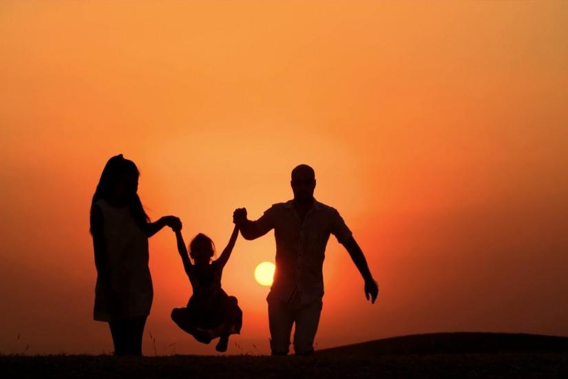 4k silhouette of a family, father mother and little daughter walking on the  background of the sunset, slow motion Stock Video Footage - VideoBlocks