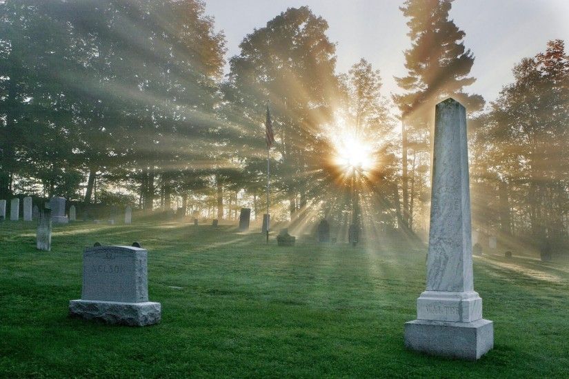 cemetery monuments flag rays sun