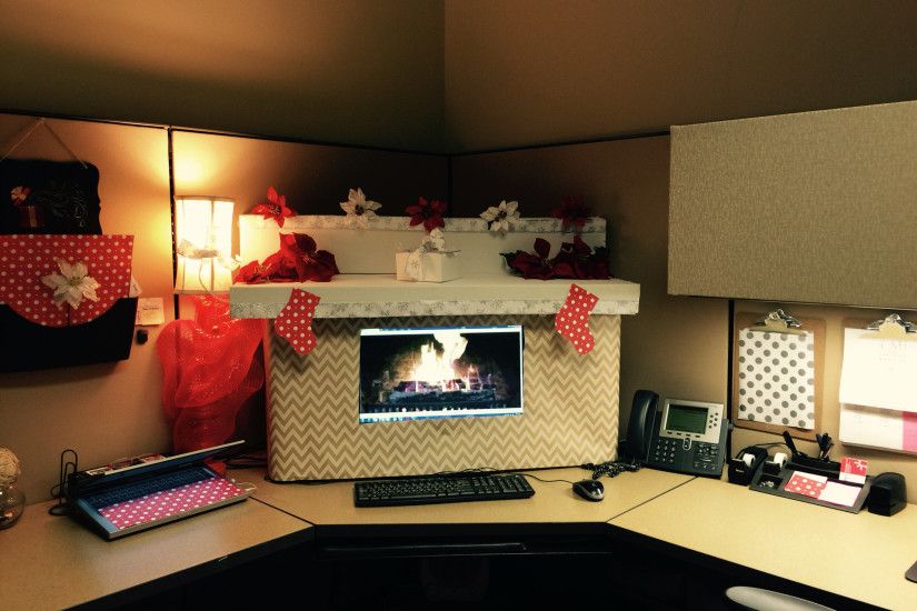 My Christmas ready office cubicle decor! I used boxes and gift wrap cut  around the monitor and a fireplace background.