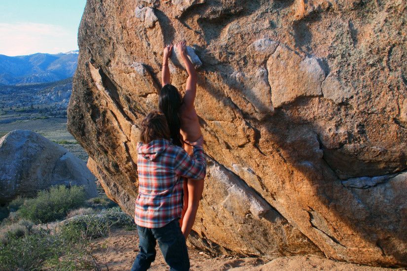 Chris Sharma helps girlfriend Daila Ojedo onto the rock.