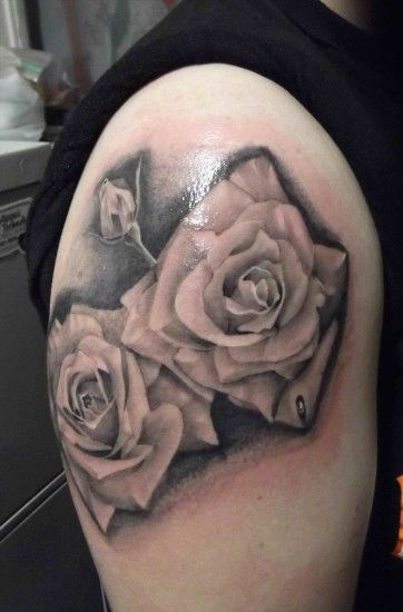 Rose with black background tattoo and grey angel with clock red rose tattoo  on arm background .