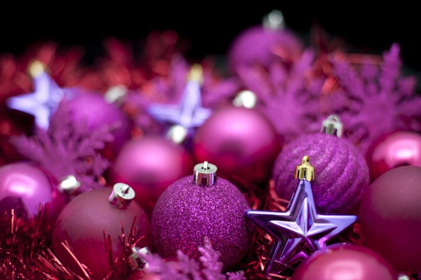Festive background of purple Christmas decorations, baubles and stars with  shallow dof