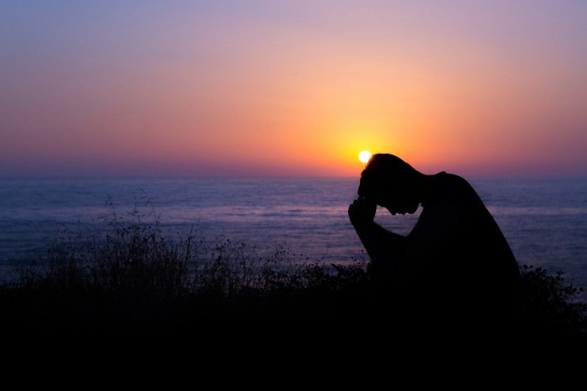 Sad Boy Wallpaper praying by the sea at sunset