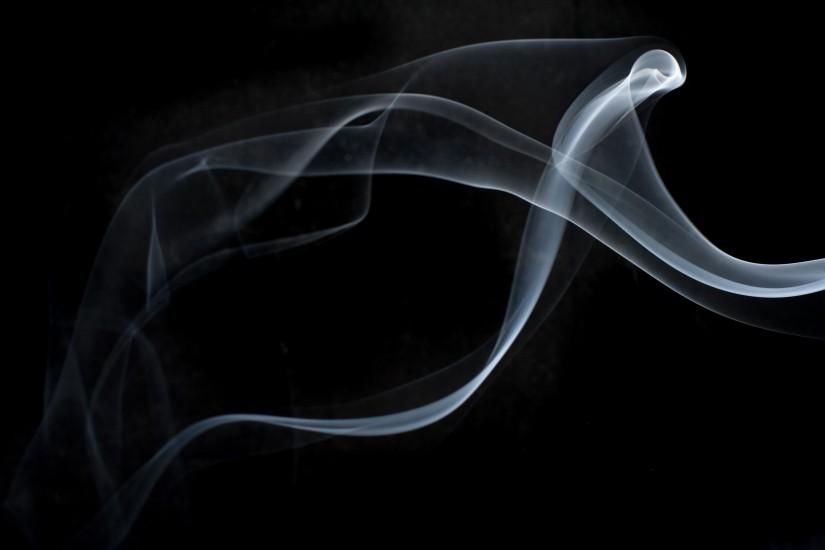 a background of mystical layers of smoke on black