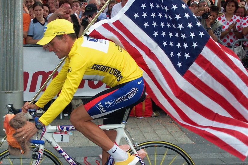 The 2000 Tour de France winner Lance Armstrong is supported by spectators  during his victory lap