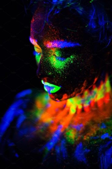 Beautiful extraterrestrial model woman in neon light. It is portrait of  beautiful model with fluorescent