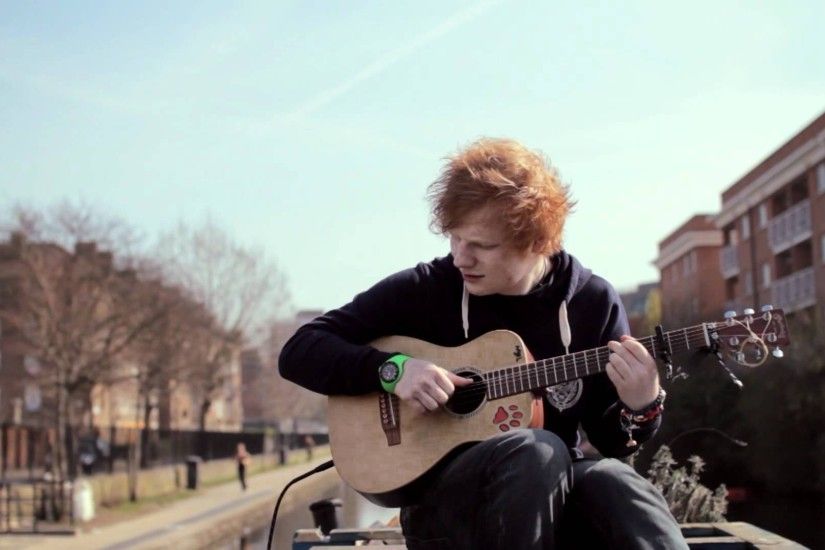 Ed Sheeran Wallpaper, Ed Sheeran is playing his guitar.
