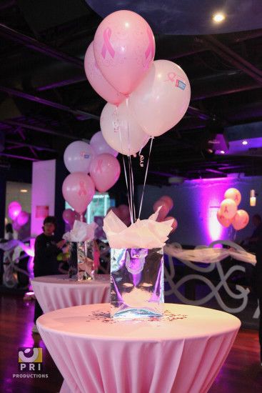 Pink balloon and gift bag centerpiece with matching table linens for a Breast  Cancer Awareness event