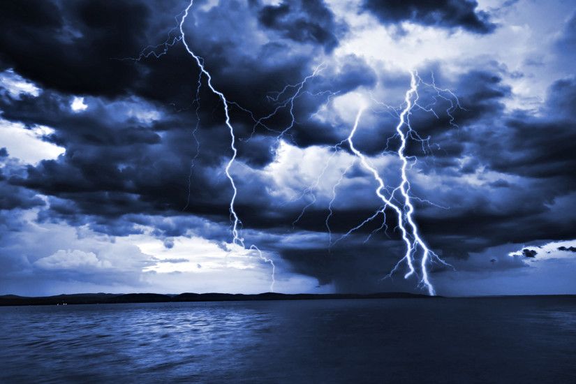 Lightning Storm at Sea | Massive thick lightning bolts hit the distant land  as viewed from