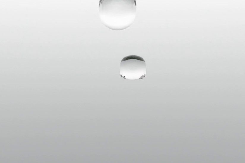 Animation of two water droplets in ultra slow motion colliding with each  other in vertical position