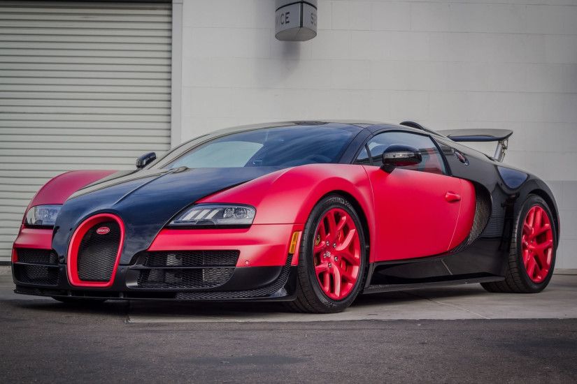 Red and black Bugatti Veyron Super Sport in grey wall