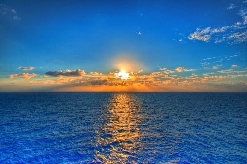 Sunset On Blue Sea Water