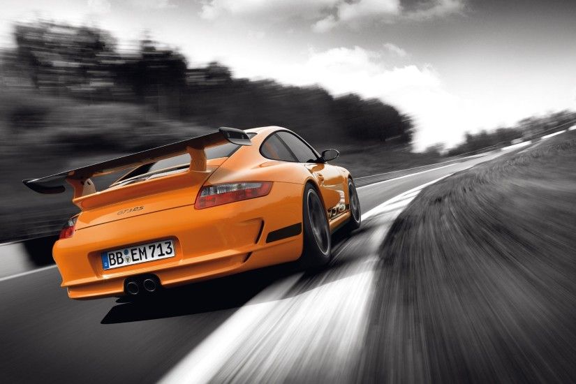 Orange Porsche GT3RS on gray highway