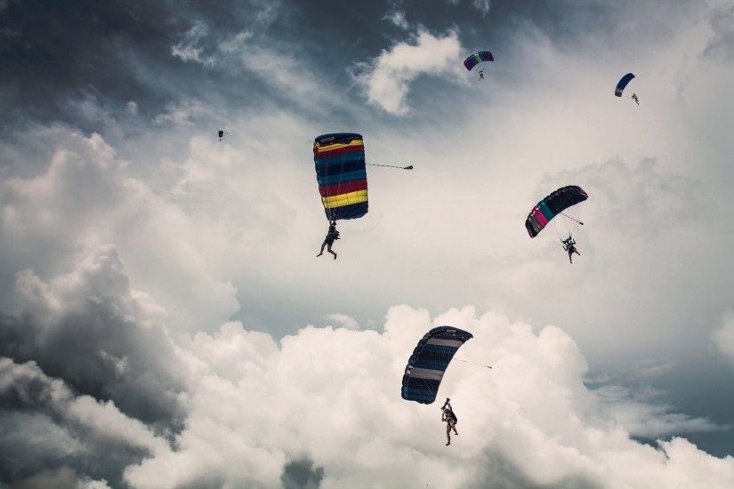 parachutist parachute skydiving clouds sky