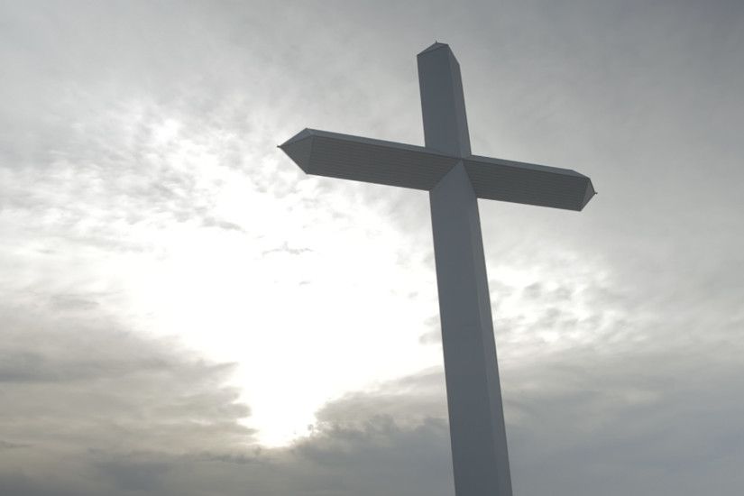 Giant cross with sun in background and overcast sky in Groom, TX