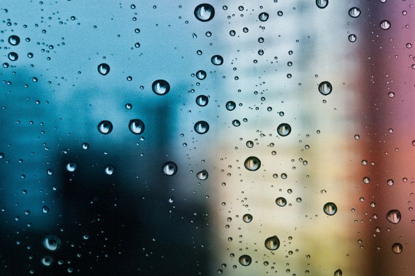 Rain drops on the window blurred city background