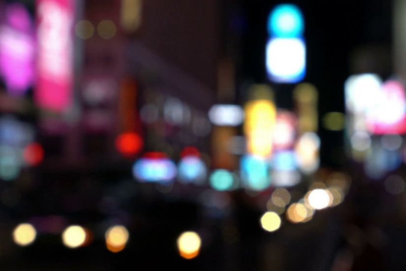Night city lights and traffic background, New York, Times Square. Out of  focus background with blurry unfocused city lights and driving cars and car  light.