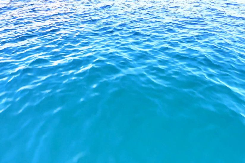 Subscription Library Flying fast above water. Blue sea ripples and waves  loop seamless background