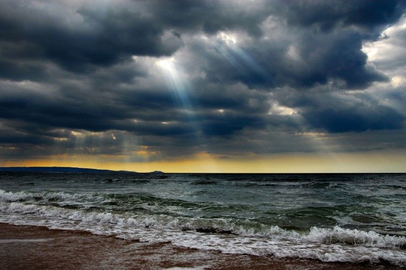 Ocean Stormy Clouds Sun Rays wallpapers and stock photos