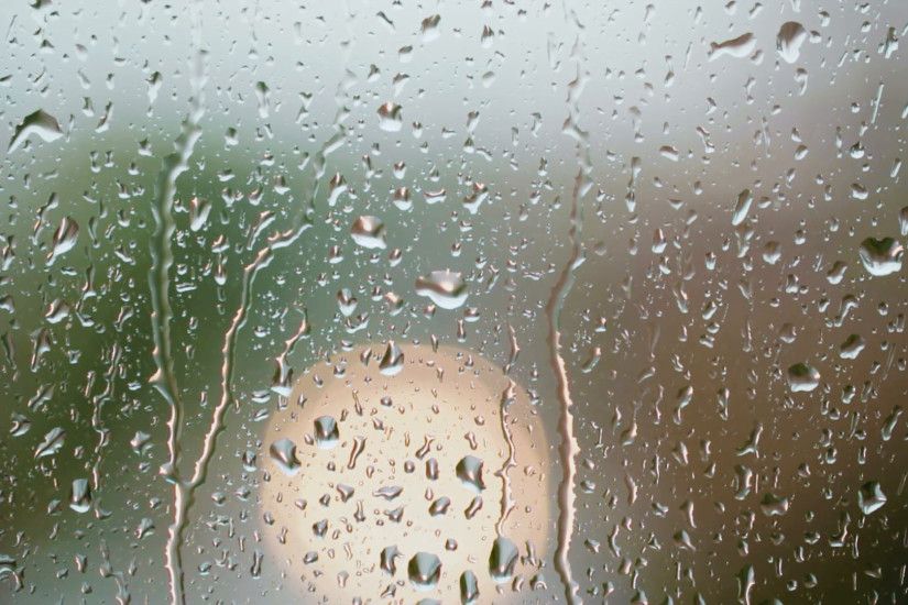 Rain drops on a window with an out of focus vehicle moving in the background.  Stock Video Footage - VideoBlocks