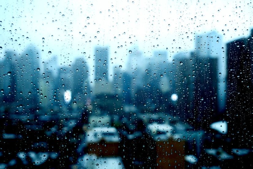 blurry city skyline window view. sad bad weather. rain drops background