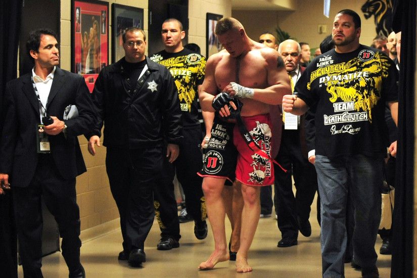 Brock Lesnar walks back to his locker room after announcing his retirement  after his loss to