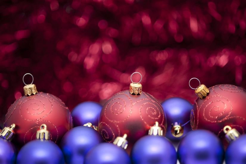 sumptuous red and purple coloured christmas background, baubles in .