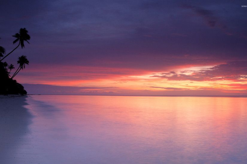 Purple sunset at white sandy beach wallpaper