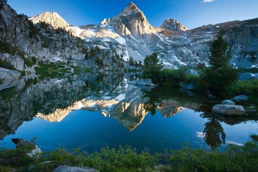 Mountains reflected in the crystal clear water wallpaper