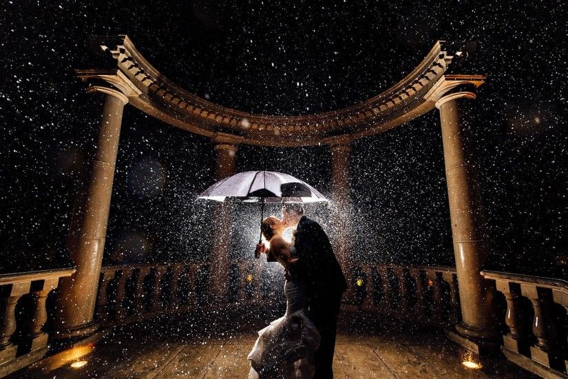 kiss in rain under umbrella