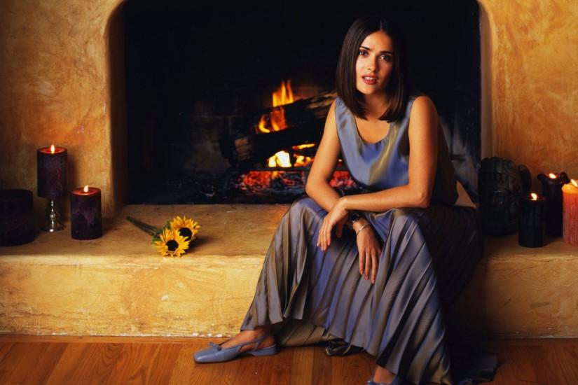 Salma Hayek in front of fireplace wallpaper
