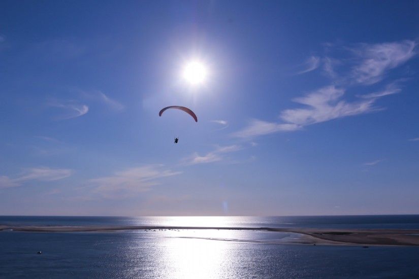 sky clouds sun sea parachute paragliding