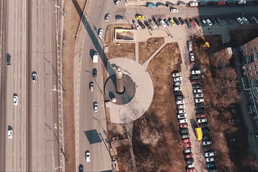 Bird eye view of Yuri Gagarin metal monument on road rush traffic crossroad  in city dormitory area under clear blue sky on summer sunny day Stock Video  ...