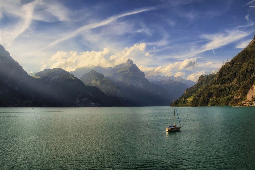 Lonesome small boat on the lake surrounded by the mountains wallpaper  1920x1200 jpg