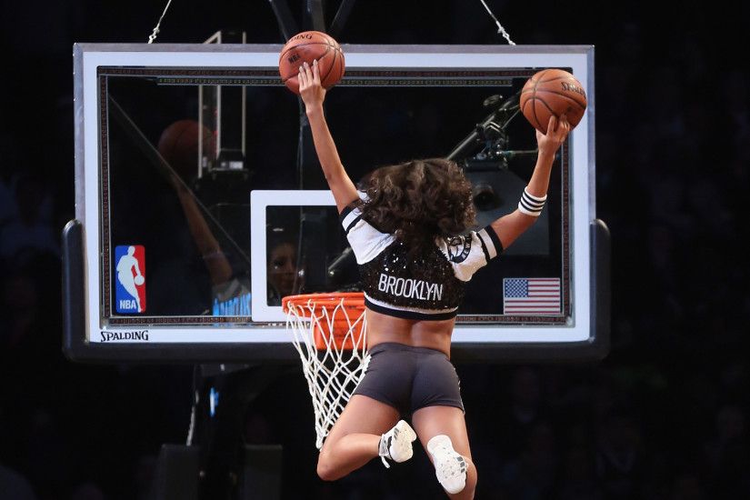 A Brooklynette cheerleader flies in to score two during a break in the game  between the Brooklyn Nets and the Los Angeles Clippers at the Barclays  Center on ...