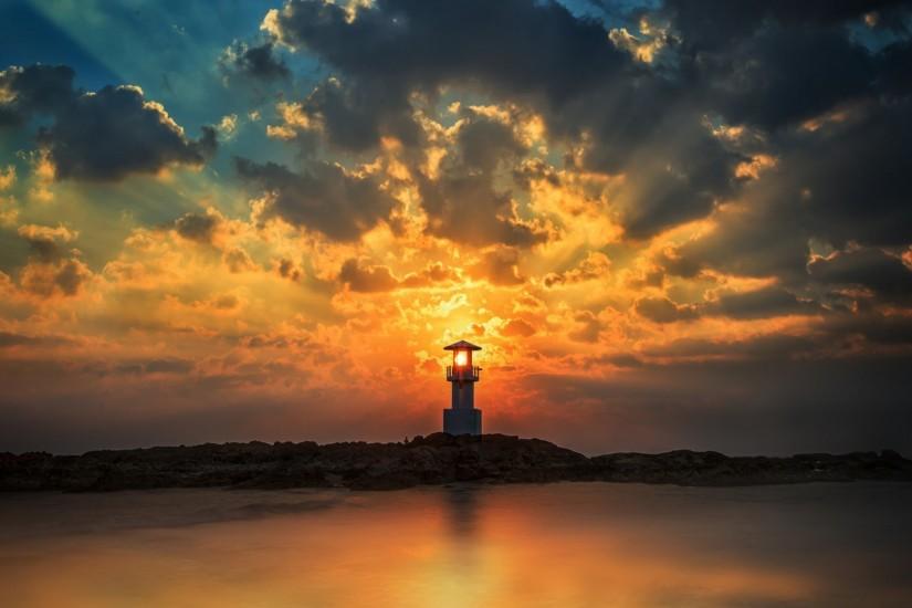 Sunset sun light through the tower of the lighthouse wallpaper