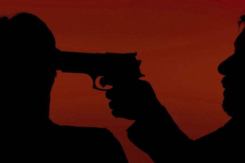Silhouettes handgun man robbing woman red. A man pointing a handgun to a  woman's temple. Crime, robbery, violence. Silhouette shot. Red background.