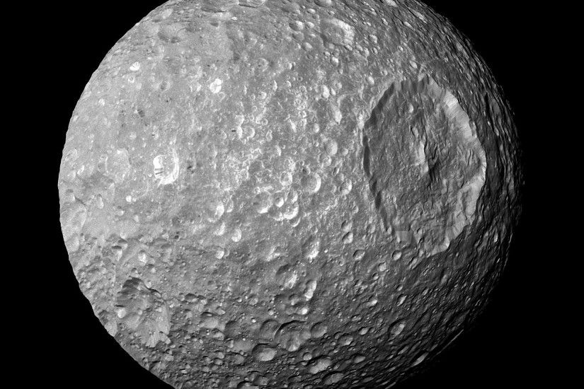 In this view captured by NASA Cassini spacecraft on its closest-ever flyby  of Saturn moon Mimas, large Herschel Crater dominates Mimas, making the  moon look ...