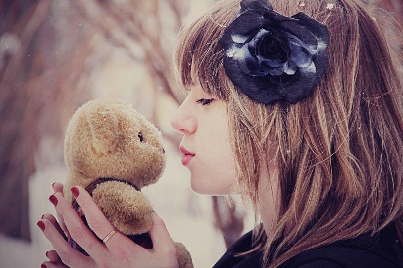 She kisses her teddy bear