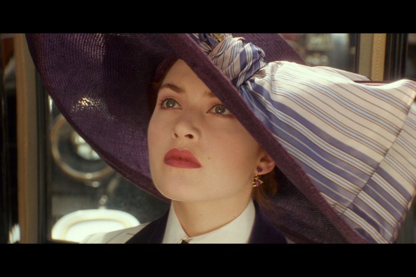 The first time we see Kate Winslet's face, it's from underneath a giant  purple hat.