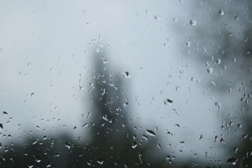 Rain drops on window glass with blur background. Blurred tree and sky.  Rainy days, rain running down window, bokeh Stock Video Footage -  VideoBlocks