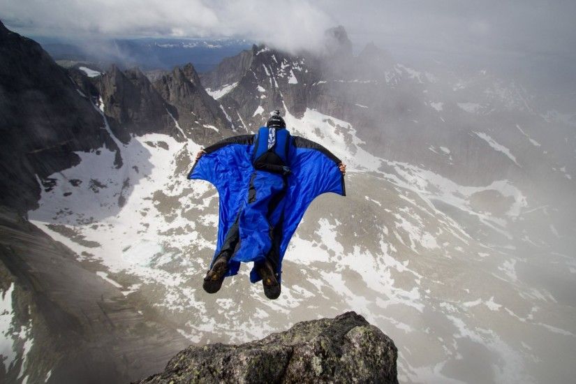 wingsuit pilot base jumping base jumper mountain rock clouds trailers  parachute extreme sports