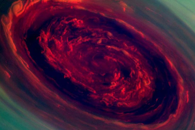 The spinning vortex of Saturn's north polar storm resembles a giant red  rose in this false